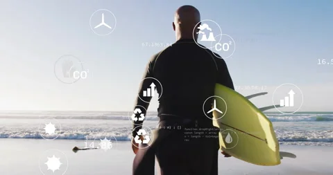 Surfer man standing on sandy shoreline gathering tech data through floating Stock Footage 308386401