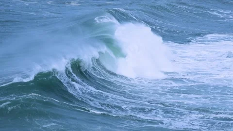 Surfer on Massive Ocean Wave Curling with Spray in Vibrant Blue Waters Stock Footage 297511593