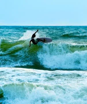Surfer in the ocean. Bali Stock Photos