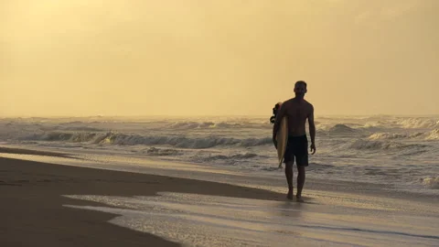 Surfer on the ocean at sunset. Stock Footage 131124398