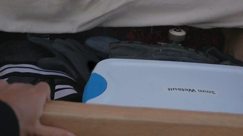 Surfer opens drawer full of gear Stock Footage 87715882