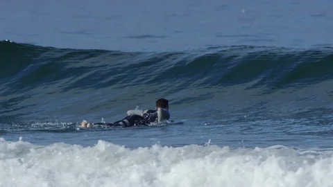 Surfer Paddles Out, Ducks Under Wave, Slow Motion Video stock 92738245