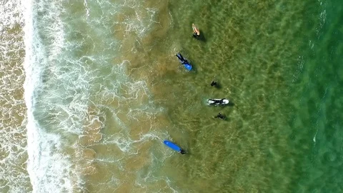Surfer paddling around waves Stock Footage 99766610