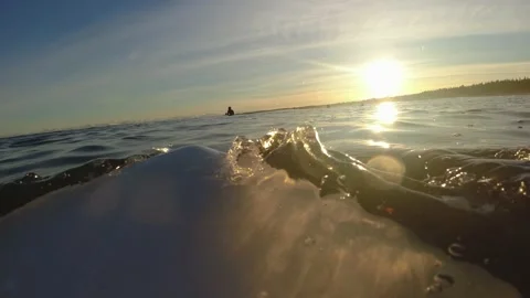 Surfer Paddling on Baltic Sea Waves at Sunrise POV Slow Motion Stock Footage 169057053