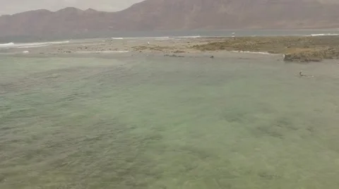 Surfer paddling in to Ocean Video stock 68283980