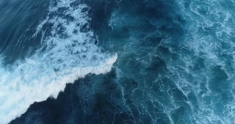 Surfer paddling out through waves Stock Footage 96132251