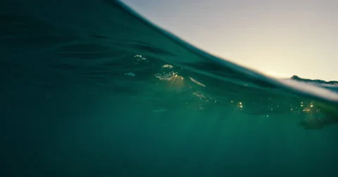 Surfer Paddling Over Ocean Wave Stock Footage 65026586
