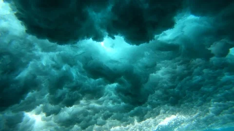 Surfer paddling over wave and underwater spinning vortex view over coral reef Stock Footage 90990627