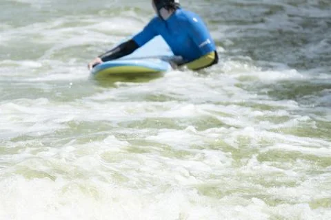 Surfer Paddling Through Artificial Wave Pool 스톡 사진