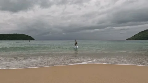 Surfer paddling towards the sea Stock Footage 220659225