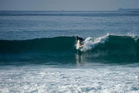 Surfer on perfect blue aquamarine wave, empty line up, perfect for surfing, c Stock Photos