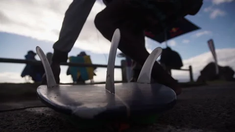 Surfer picks up his surfboard. Video stock 144088543