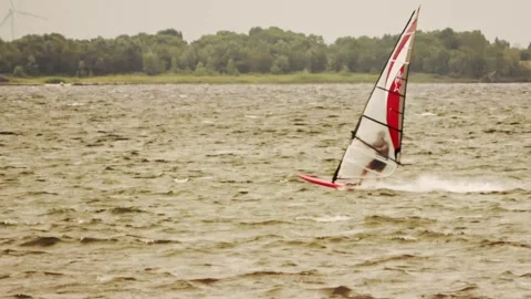 Surfer with red and white sail to the left Video stock 254469887