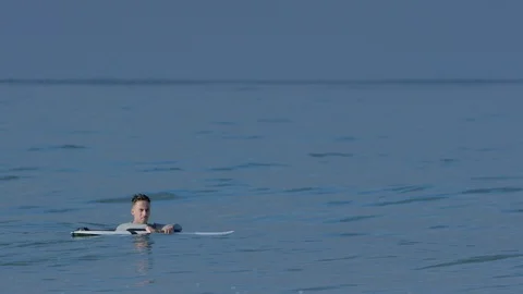 Surfer Relaxes Between Waves, Holds Up A Hang Loose Hand Gesture (Slow Motion) Stock Footage 92739445