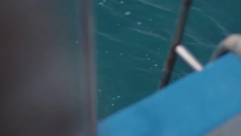 Surfer returns from the surfing session and gets on the surf taxi boat Stock Footage 346641525
