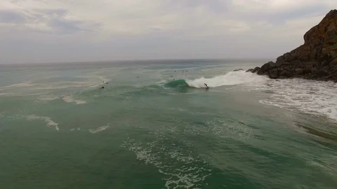 A surfer rides a wave. About nature, dominate nature, sports, risk, adrenaline, Stock Footage 71613441