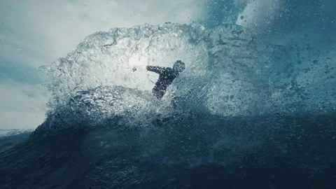 Surfer rides the wave and does radical maneuver and sprays a lot of water with Stock-Footage 334641913