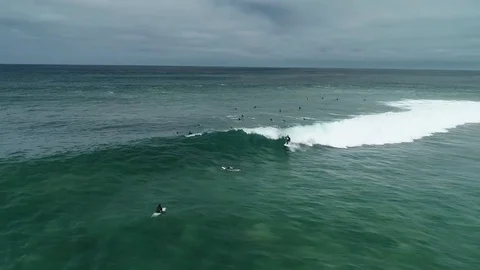 Surfer rides a wave at Bells Beach on a cloudy day surf coast Australia Video stock 127083591