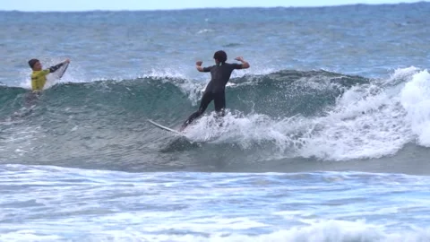 Surfer rides a wave in slow motion. 動画素材 231480124