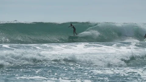 Surfer rides waves before bailing from the board Video stock 93722757