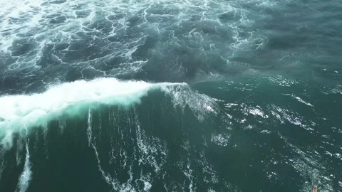 Surfer rides the waves on the black beaches of Bali Stock Footage 258140338