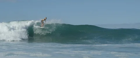 Surfer riding a big wave in slow motion Stock Footage 108641659
