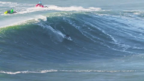 Surfer is riding big wave.Extremal big wave surfing. Nazare, Portugal Stock Footage 302563273