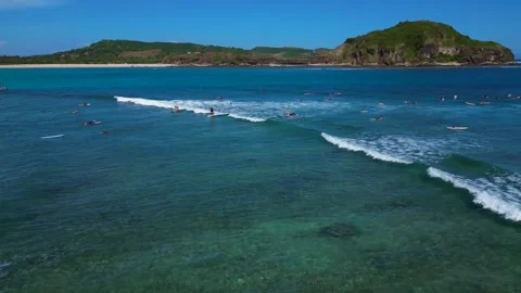 Surfer riding a blue ocean wave on a sunny day. Nice aerial view drone Stock Footage 344614901