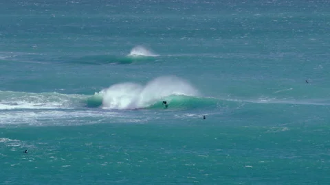 Surfer riding bright turquoise wave with white spray 動画素材 332739451