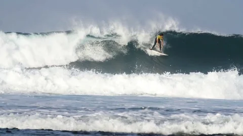 Surfer riding a giant wave Stock Footage 71547125