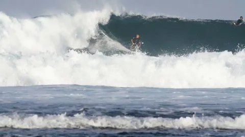 Surfer riding a giant wave Stock Footage 71547836