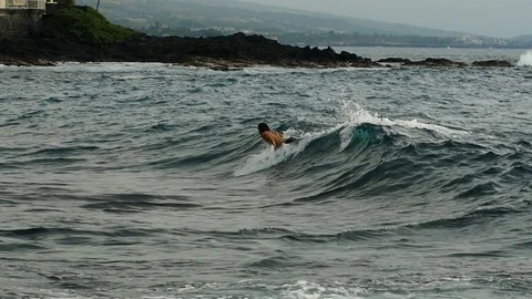 A surfer riding an ocean wave Stock Footage 84783224