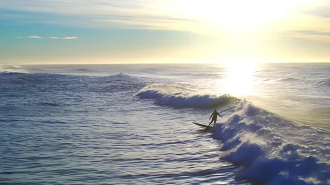 Surfer riding a perfect ocean wave at sunset Stock Footage 337031220