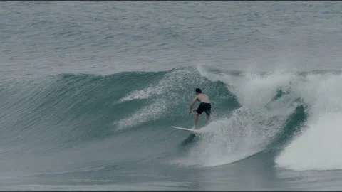 Surfer riding a wave and stalling into a barrel Stock Footage 169074460