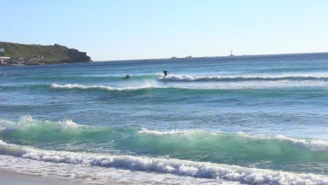Surfer riding wave on beach Stock Footage 86608443
