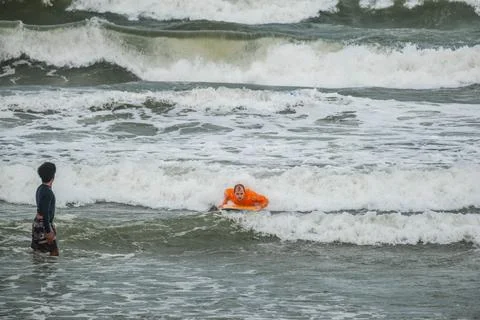 Surfer Riding a Wave During a Lesson with an Instructor Stock Photos