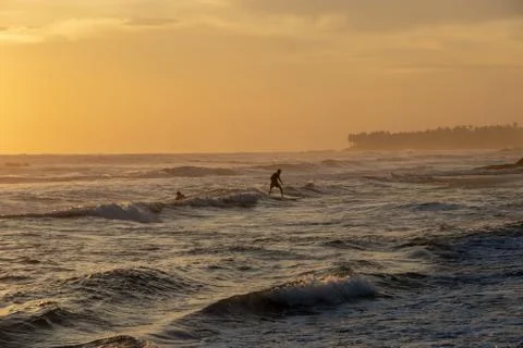 Surfer riding wave at Echo Beach Canggu Bali Indonesia Stock Photos