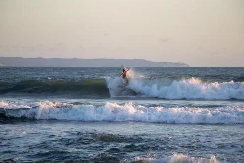 Surfer riding wave at Echo Beach Canggu Bali Indonesia Stock Photos