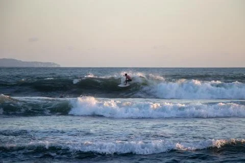 Surfer riding wave at Echo Beach Canggu Bali Indonesia Stock Photos