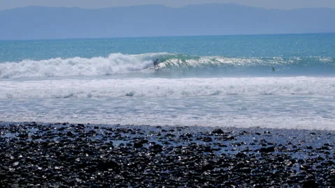 Surfer riding a wave at Pavones beach, Costa Rica Stock Footage 336874611