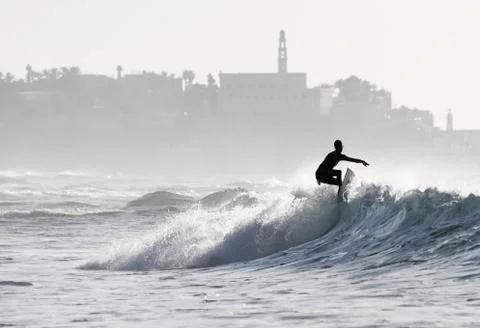 Surfer riding a wave Stock Photos