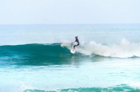 Surfer riding the wave Stock Photos
