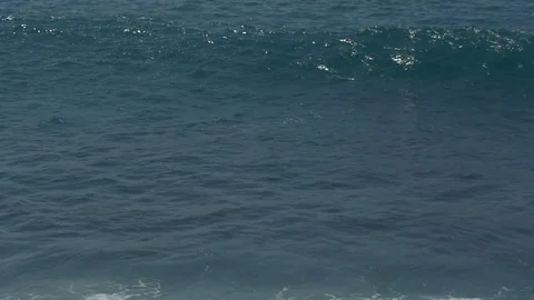 A surfer riding a wave in slow motion Stock Footage 84809651