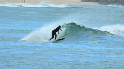Surfer riding waves along dramatic coastline (7) , 27/08/2025 Stock Photos