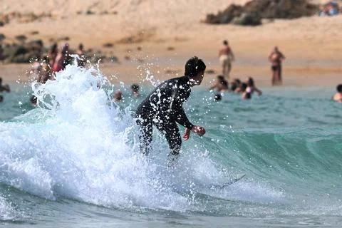 Surfer riding waves along dramatic coastline (6) , 27/08/2025 Stock Photos