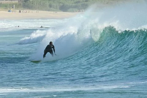 Surfer riding waves along dramatic coastline (8) 27/08/2025 Stock Photos