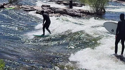 Surfer riding whitewater rapids at Brennans Wave in Missoula while one waits 스톡 동영상 339974642