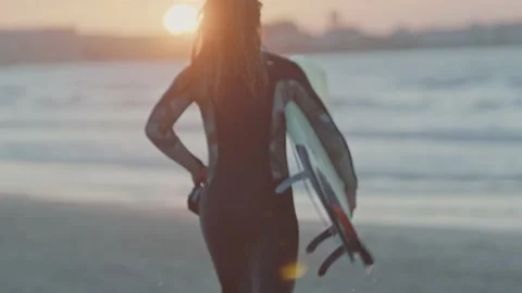 Surfer running on beach 2 Stock Footage 228386401