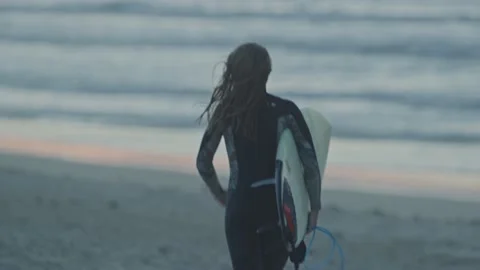 Surfer running on beach Stock Footage 228386561
