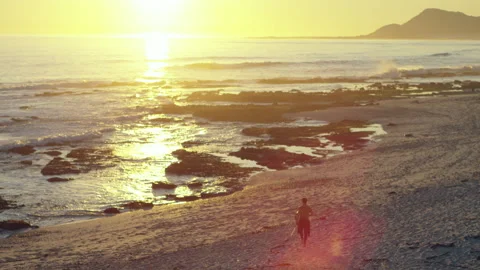 Surfer running on the beach Stock Footage 279784090